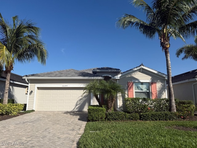 16249 Bonita Landing Cir, Bonita Springs, FL 34135 - ranch-style house with decorative driveway and an attached garage