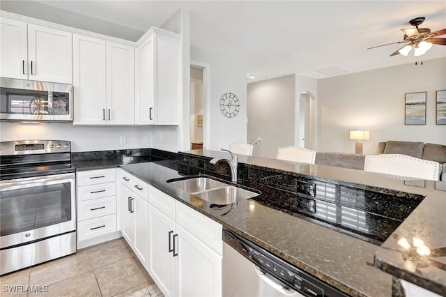 11830 Paseo Grande Blvd Unit 4608, Fort Myers, FL 33912 - kitchen featuring stainless steel appliances, a sink, ceiling fan, dark stone countertops, and white cabinetry