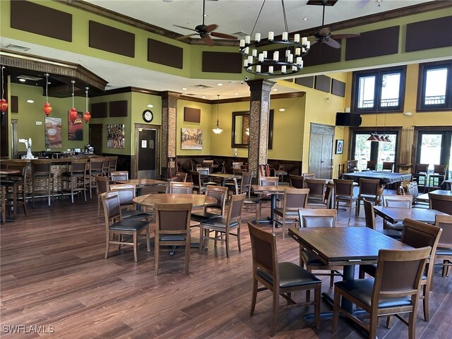 11830 Paseo Grande Blvd Unit 4608, Fort Myers, FL 33912 - dining area with a ceiling fan, a towering ceiling, ornamental molding, ornate columns, and wood finished floors
