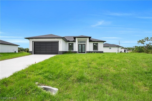 643 Knapp St, Lehigh Acres, FL 33974 - prairie-style home with an attached garage, concrete driveway, stucco siding, and a front yard