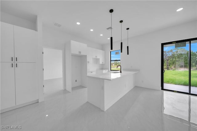 643 Knapp St, Lehigh Acres, FL 33974 - kitchen with white cabinets, modern cabinets, a peninsula, recessed lighting, and light countertops