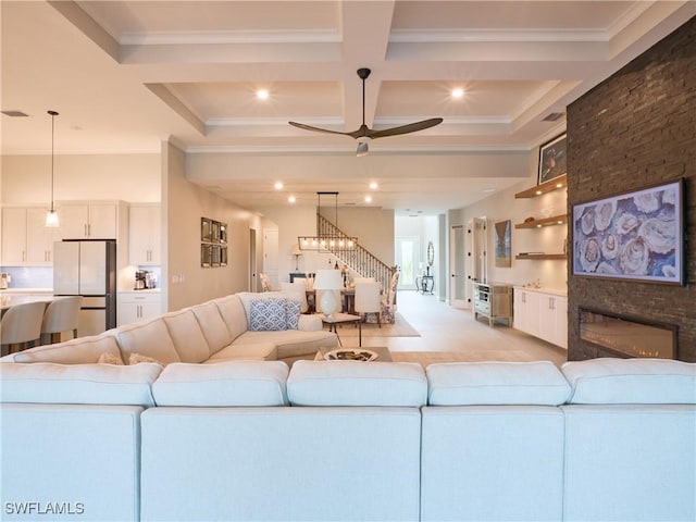 19449 The Place Blvd, Estero, FL 33928 - living area featuring crown molding, a ceiling fan, coffered ceiling, a fireplace, and beam ceiling