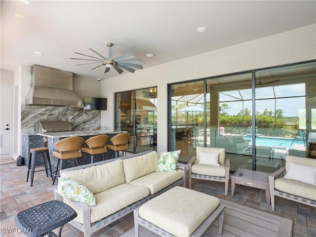 19449 The Place Blvd, Estero, FL 33928 - living area featuring ceiling fan, a sunroom, stone finish floors, and recessed lighting