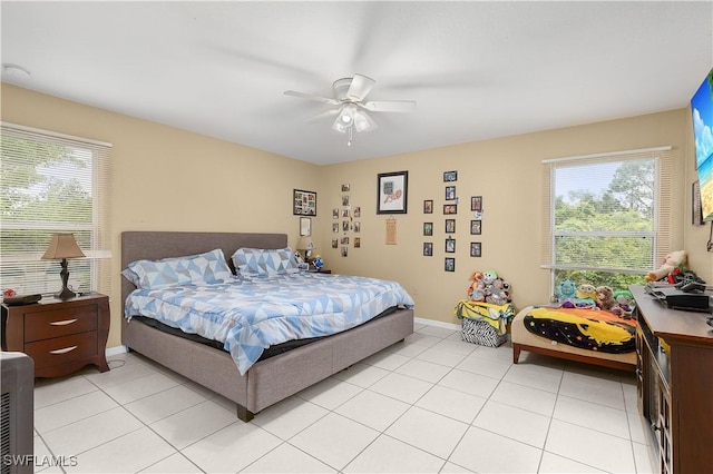 866 Carbon St E, Lehigh Acres, FL 33974 - bedroom with light tile patterned floors, ceiling fan, and baseboards