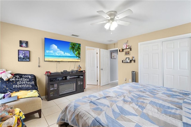 866 Carbon St E, Lehigh Acres, FL 33974 - tiled bedroom with a closet, a ceiling fan, and baseboards