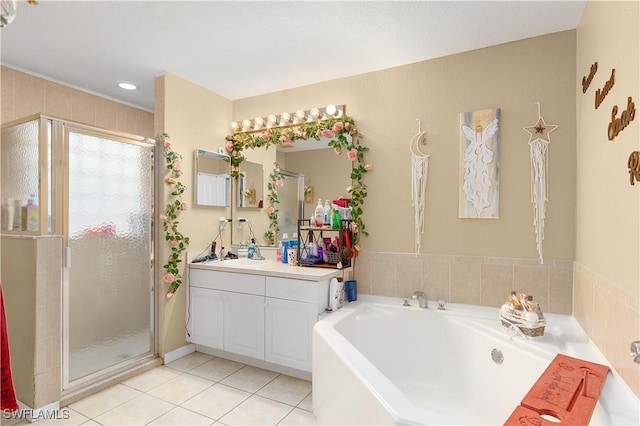 866 Carbon St E, Lehigh Acres, FL 33974 - full bath with a stall shower, vanity, tile patterned floors, and a garden tub