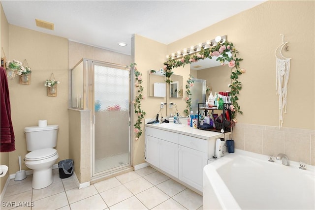 866 Carbon St E, Lehigh Acres, FL 33974 - bathroom with toilet, vanity, a shower stall, a bath, and tile patterned floors