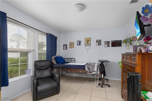 866 Carbon St E, Lehigh Acres, FL 33974 - bedroom featuring multiple windows, light tile patterned floors, and baseboards