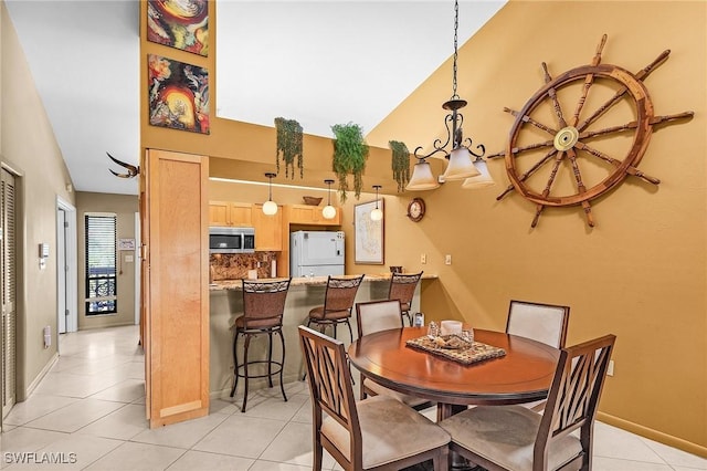 16276 Nautical Way Unit 1402, Bokeelia, FL 33922 - dining area featuring light tile patterned floors and a chandelier