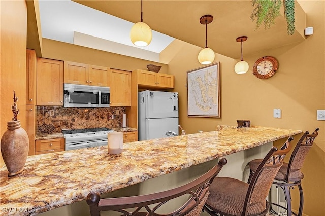 16276 Nautical Way Unit 1402, Bokeelia, FL 33922 - kitchen featuring stainless steel microwave, refrigerator, white electric stove, and a peninsula
