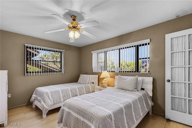 16276 Nautical Way Unit 1402, Bokeelia, FL 33922 - bedroom featuring light wood finished floors and a ceiling fan