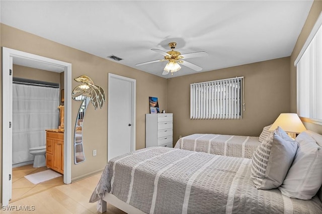 16276 Nautical Way Unit 1402, Bokeelia, FL 33922 - bedroom with light wood-style floors, a ceiling fan, and connected bathroom
