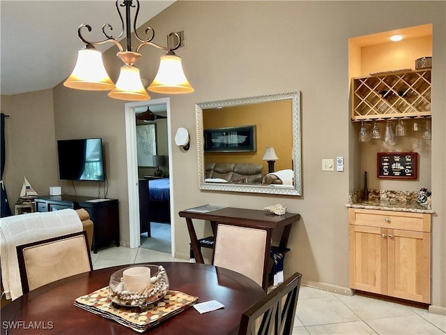 16276 Nautical Way Unit 1402, Bokeelia, FL 33922 - dining space featuring light tile patterned flooring, a dry bar, and vaulted ceiling
