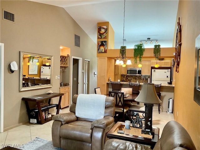 16276 Nautical Way Unit 1402, Bokeelia, FL 33922 - living area with light tile patterned flooring, high vaulted ceiling, and a chandelier