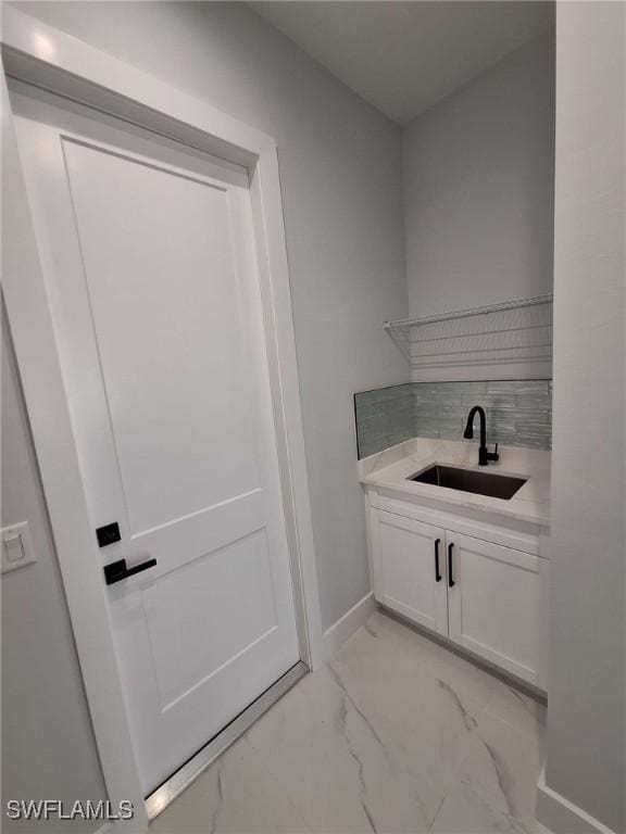 4956 30th Pl SW, Naples, FL 34116 - washroom with a sink, light marble finish flooring, and baseboards