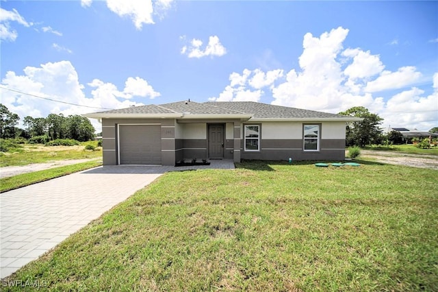 856 Chezy St E, Lehigh Acres, FL 33974 - view of front of home featuring stucco siding, a garage, decorative driveway, and a front lawn
