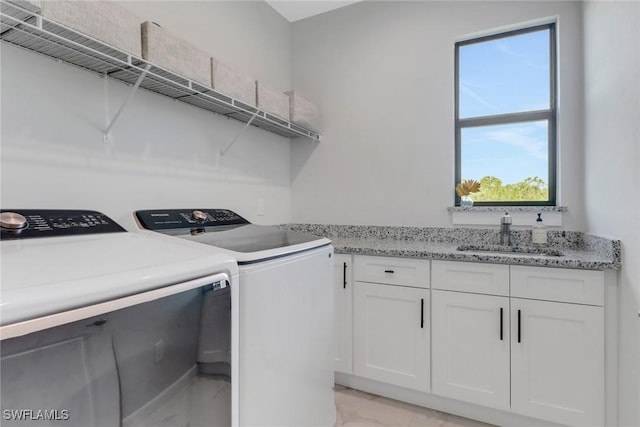 4119 43rd Ave NE, Naples, FL 34120 - laundry area with independent washer and dryer, light marble finish flooring, and cabinet space