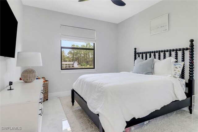 4119 43rd Ave NE, Naples, FL 34120 - bedroom featuring ceiling fan and light marble finish floors