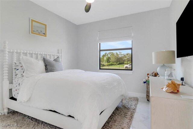 4119 43rd Ave NE, Naples, FL 34120 - bedroom with a ceiling fan and light marble finish flooring