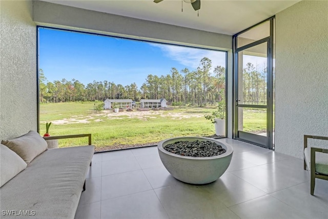 4119 43rd Ave NE, Naples, FL 34120 - sunroom / solarium featuring a ceiling fan and view of wooded area
