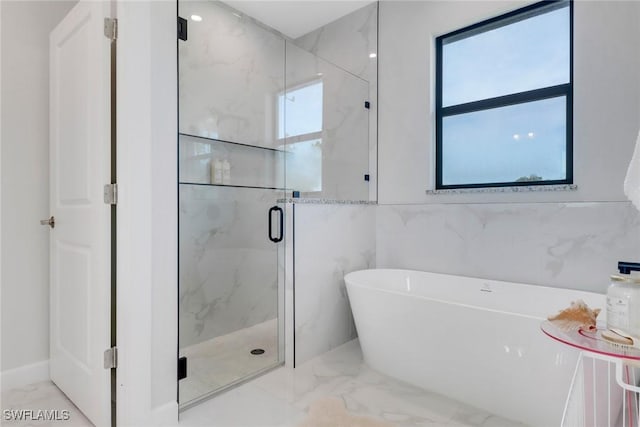 4119 43rd Ave NE, Naples, FL 34120 - full bathroom featuring marble tiled floors, a freestanding bath, and a marble finish shower