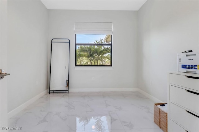 4119 43rd Ave NE, Naples, FL 34120 - spare room featuring light marble finish flooring and baseboards