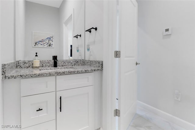 4119 43rd Ave NE, Naples, FL 34120 - bathroom featuring vanity and marble finish flooring