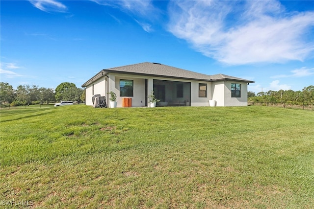4119 43rd Ave NE, Naples, FL 34120 - rear view of house featuring a yard and stucco siding
