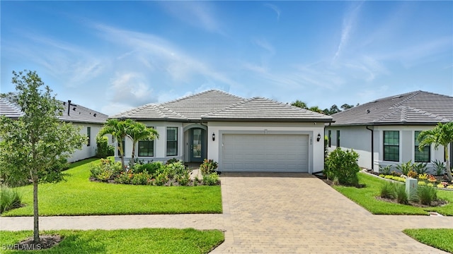 1870 Amador Ct, Naples, FL 34120 - single story home featuring a garage, decorative driveway, a front lawn, stucco siding, and a tile roof
