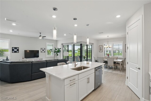 1870 Amador Ct, Naples, FL 34120 - kitchen with dishwasher, light countertops, white cabinetry, a kitchen island with sink, and hanging light fixtures