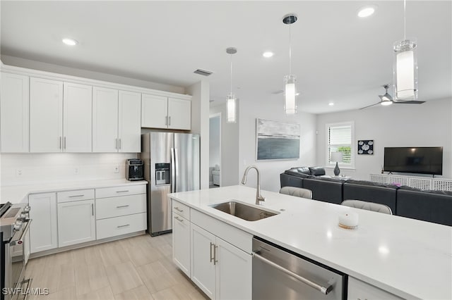 1870 Amador Ct, Naples, FL 34120 - kitchen with stainless steel appliances, open floor plan, white cabinetry, light countertops, and recessed lighting