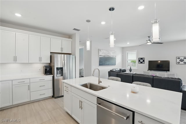 1870 Amador Ct, Naples, FL 34120 - kitchen featuring appliances with stainless steel finishes, open floor plan, white cabinetry, light countertops, and pendant lighting