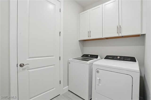 1870 Amador Ct, Naples, FL 34120 - laundry room featuring cabinet space and washing machine and clothes dryer