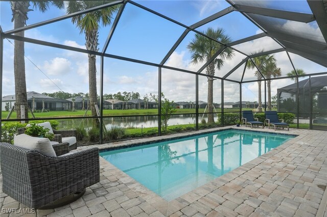 1870 Amador Ct, Naples, FL 34120 - outdoor pool featuring a patio area, a water view, glass enclosure, and a residential view