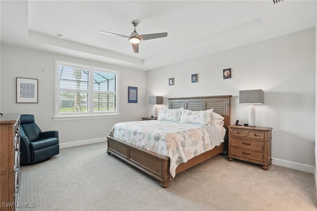 1870 Amador Ct, Naples, FL 34120 - bedroom with a raised ceiling, light colored carpet, and a ceiling fan