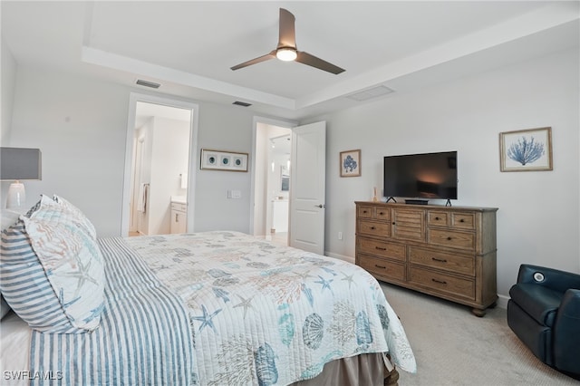 1870 Amador Ct, Naples, FL 34120 - bedroom with a tray ceiling, light colored carpet, a ceiling fan, and connected bathroom