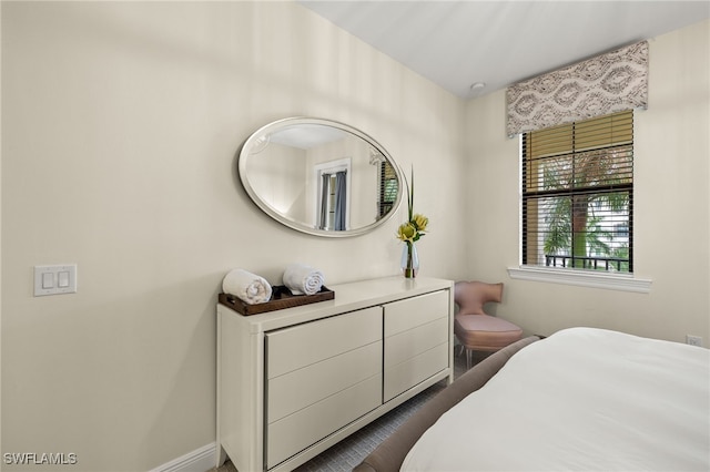 16382 Viansa Way Unit 3-202, Naples, FL 34110 - bedroom featuring baseboards and dark wood-type flooring