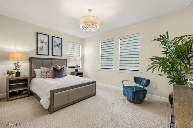 16382 Viansa Way Unit 3-202, Naples, FL 34110 - bedroom featuring carpet floors, baseboards, and a chandelier