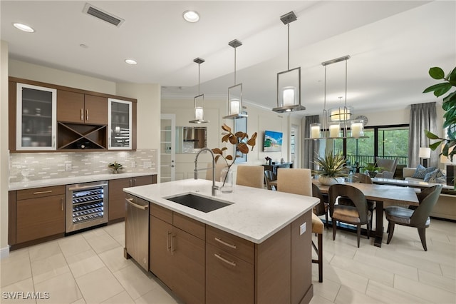 16382 Viansa Way Unit 3-202, Naples, FL 34110 - kitchen featuring a sink, beverage cooler, dishwasher, backsplash, and open floor plan