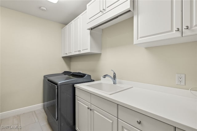 16382 Viansa Way Unit 3-202, Naples, FL 34110 - washroom featuring cabinet space, baseboards, independent washer and dryer, and light marble finish flooring