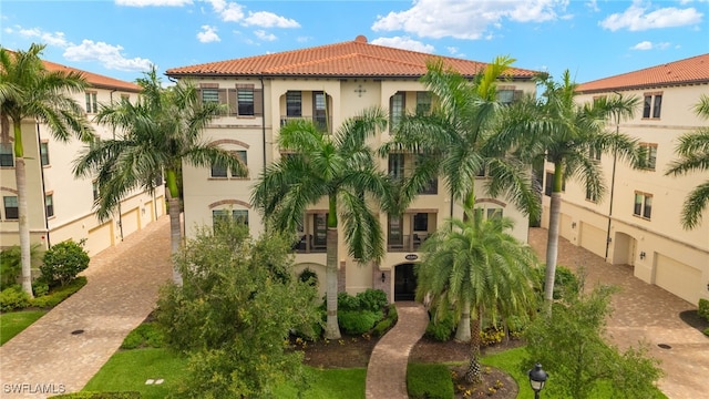 16382 Viansa Way Unit 3-202, Naples, FL 34110 - view of building exterior featuring driveway and an attached garage