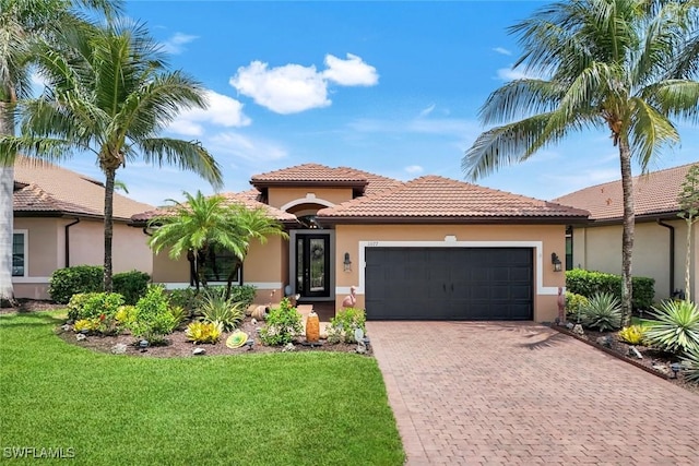11177 Monte Carlo Blvd, Bonita Springs, FL 34135 - mediterranean / spanish home with an attached garage, stucco siding, decorative driveway, a front yard, and a tile roof
