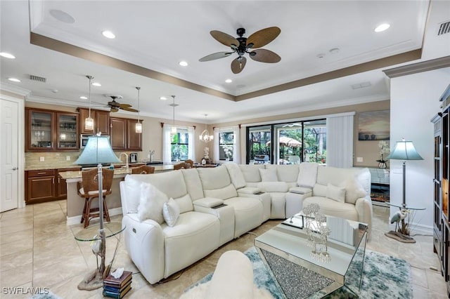 11177 Monte Carlo Blvd, Bonita Springs, FL 34135 - living room with a ceiling fan, crown molding, a tray ceiling, and recessed lighting