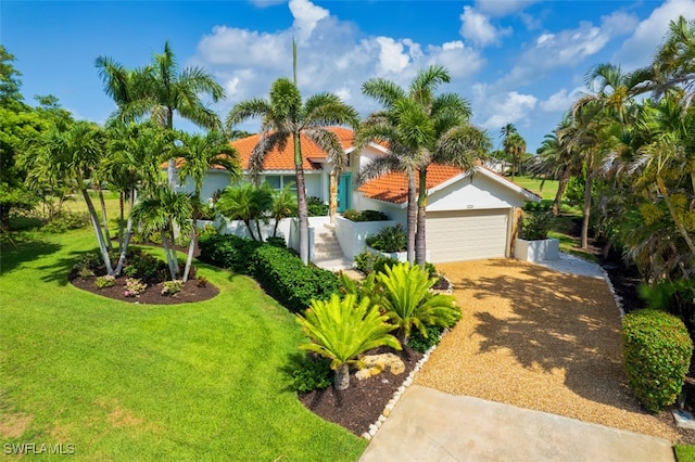 1226 Par View Dr, Sanibel, FL 33957 - mediterranean / spanish home featuring driveway, a front yard, an attached garage, stucco siding, and a tile roof