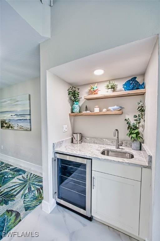 1226 Par View Dr, Sanibel, FL 33957 - indoor wet bar with wine cooler, baseboards, and light marble finish flooring