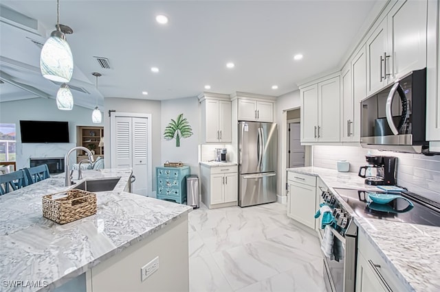 1226 Par View Dr, Sanibel, FL 33957 - kitchen featuring appliances with stainless steel finishes, light stone counters, recessed lighting, light marble finish floors, and decorative backsplash