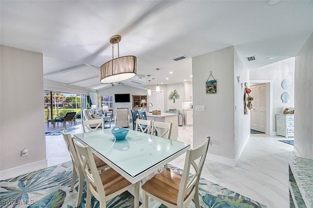 1226 Par View Dr, Sanibel, FL 33957 - dining space with baseboards, vaulted ceiling, and light marble finish floors