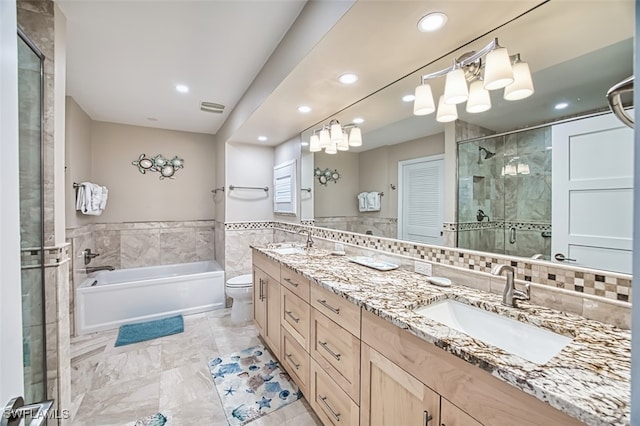 1226 Par View Dr, Sanibel, FL 33957 - full bath with tile walls, a shower stall, double vanity, a garden tub, and recessed lighting