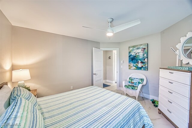 1226 Par View Dr, Sanibel, FL 33957 - bedroom with light marble finish floors, ceiling fan, and baseboards