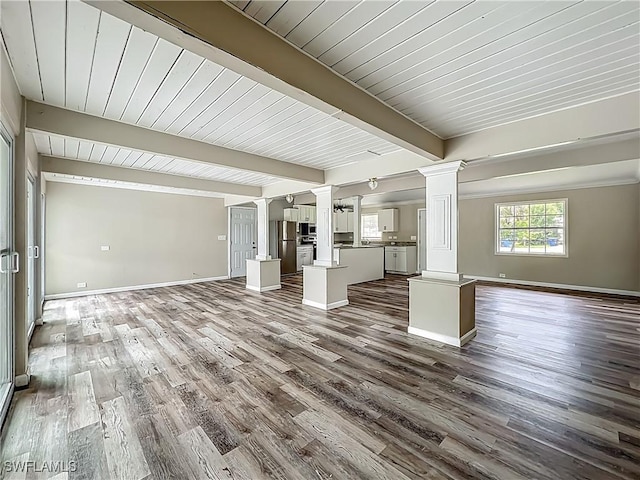 93 E Mariana Ave, North Fort Myers, FL 33917 - unfurnished living room featuring decorative columns, dark wood-type flooring, and a wood ceiling with exposed beams